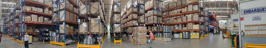 Employees working in a busy and full DSV warehouse. 