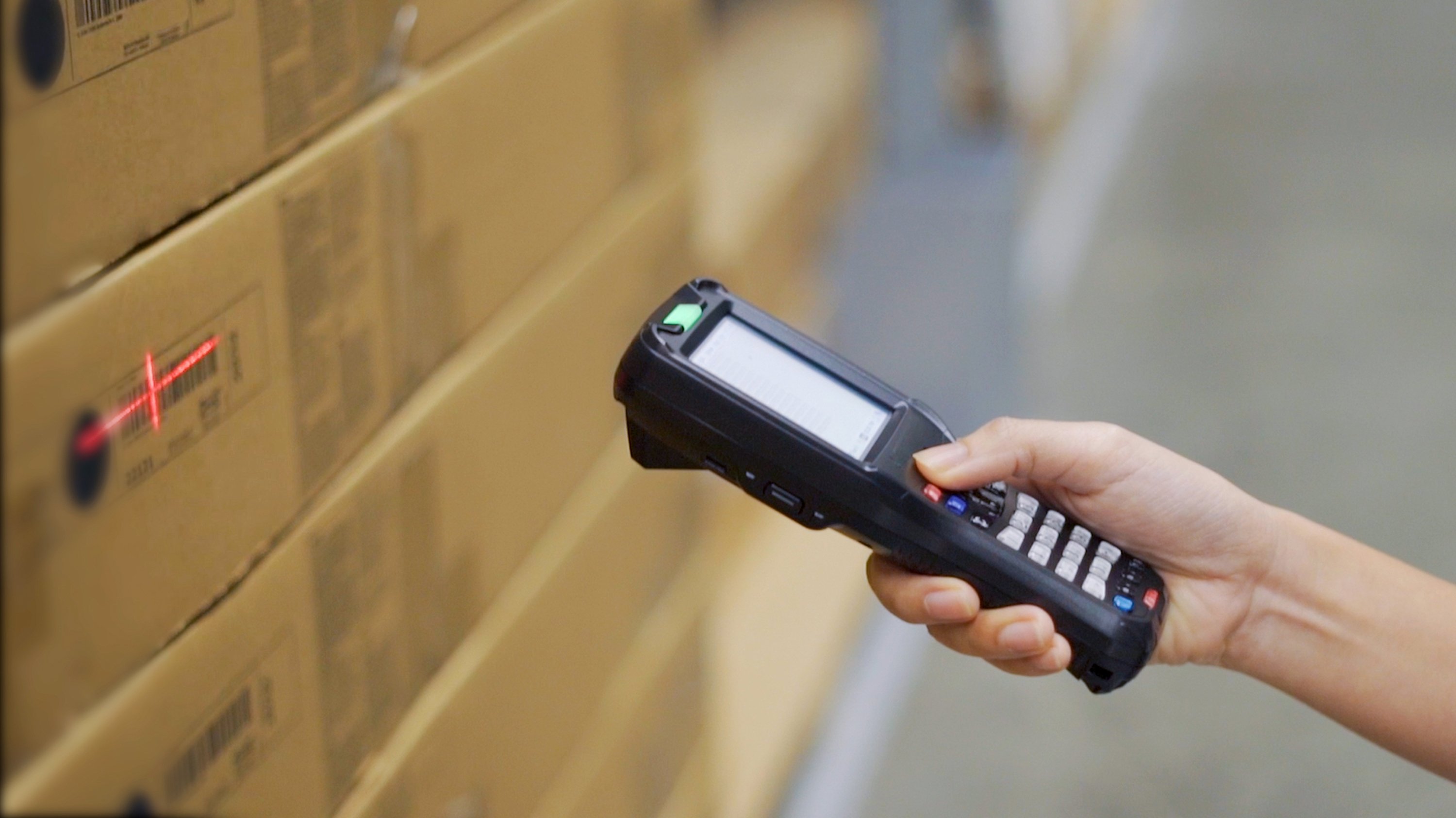 RFID scanner being used to scan boxed in a warehouse.