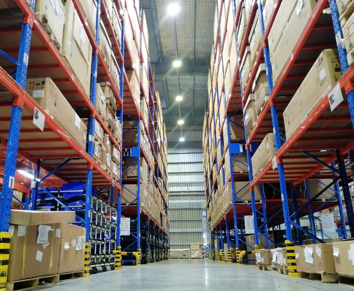 Warehouse shelves full of boxes and items in storage.