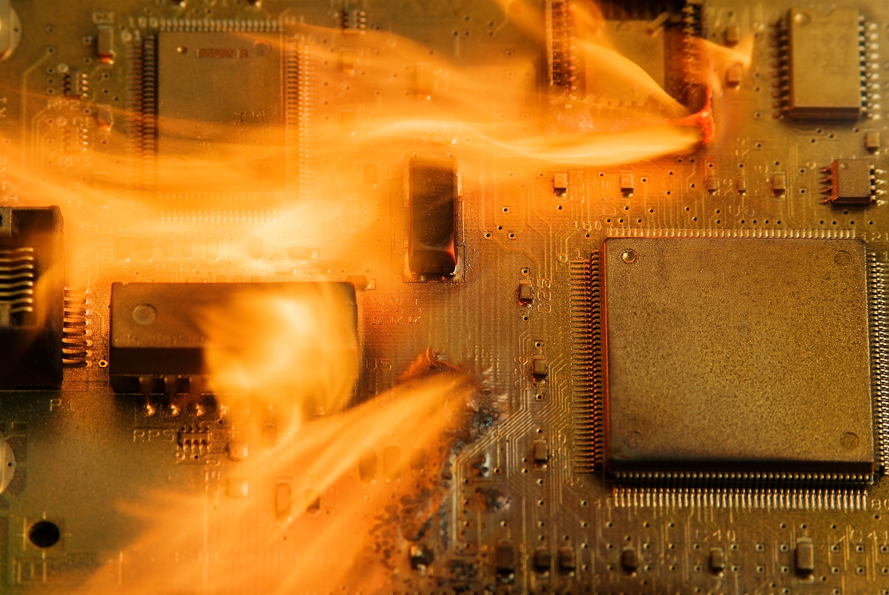 Microchips burning on a printed circuit board.