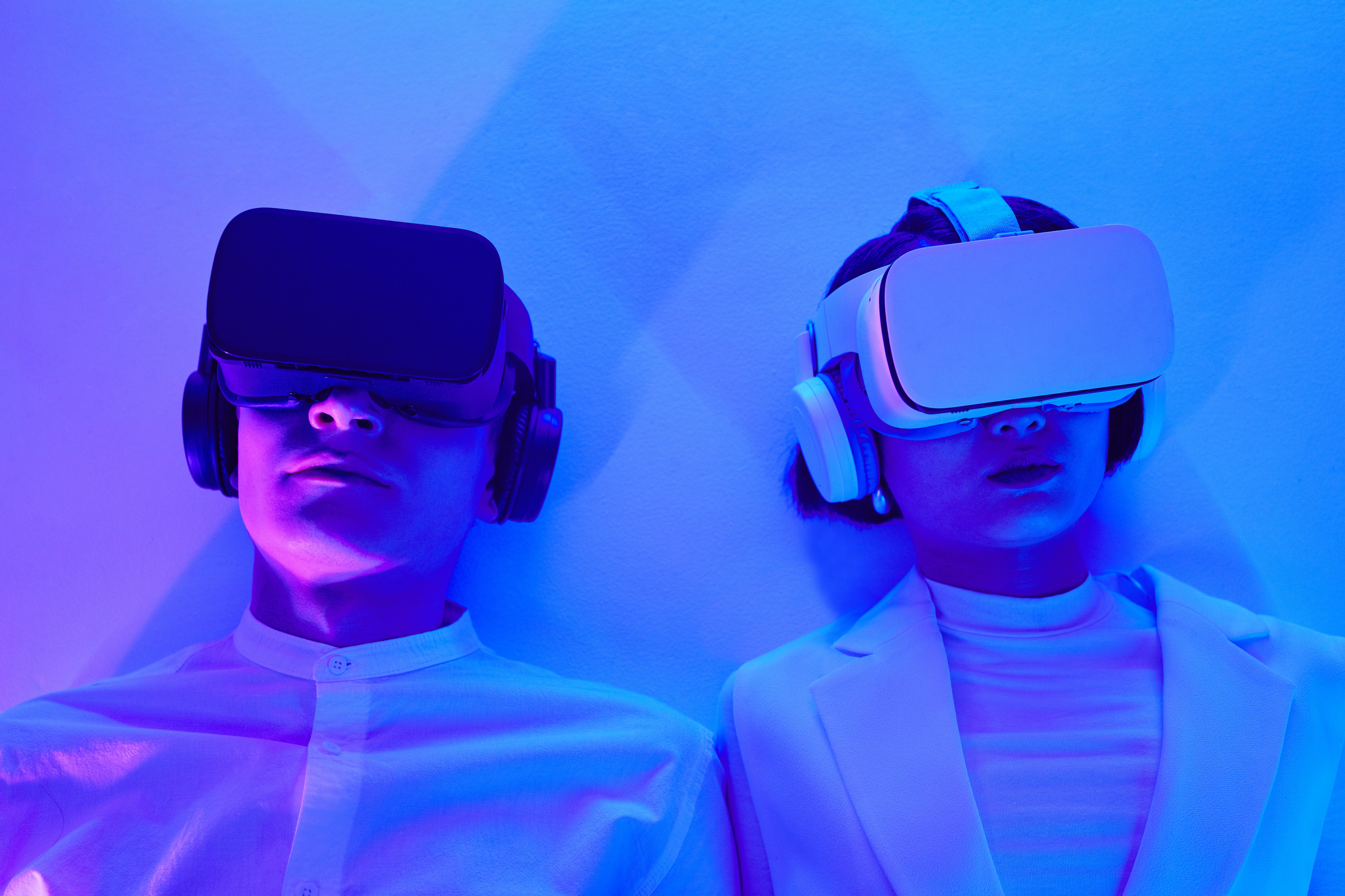 Two people wearing VR headsets. 