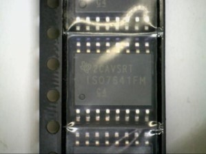 Electronic component in a reel highlighting a small pin one marker.